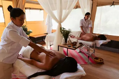 a woman getting a mans back in a massage room at Las Qolqas EcoResort Ollantaytambo in Ollantaytambo