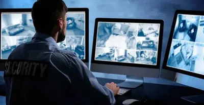 a man sitting at a desk in front of a computer at Hospedaje Pueblo Viejo in Casa Blanca