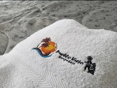 a white towel with a picture of an orange on it at Hospedaje Pueblo Viejo in Casa Blanca