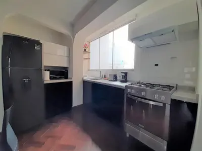 a kitchen with a black refrigerator and a stove at Miraflores Kennedy's Park Apartment in Lima