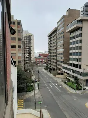 an empty street in a city with tall buildings at Miraflores Kennedy's Park Apartment in Lima