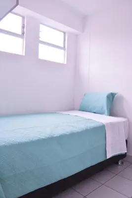 a bed in a white room with two windows at KYRA APARTMENTS - Central Miraflores - Spacious 4BR for 07 guests in Lima