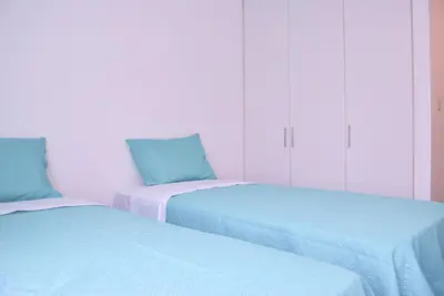 two beds sitting next to each other in a room at KYRA APARTMENTS - Central Miraflores - Spacious 4BR for 07 guests in Lima