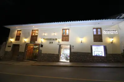 a building on the side of a street at night at Hotel Choquequirao in Cusco