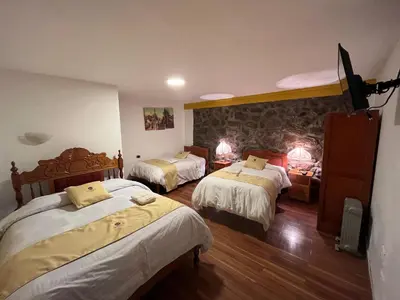 a hotel room with two beds in a room at Hotel Choquequirao in Cusco