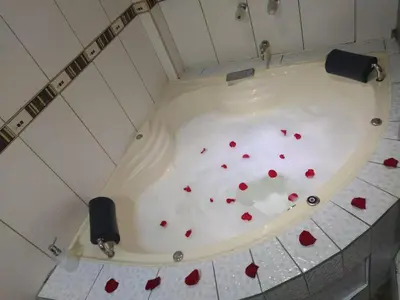 a bath tub filled with red hearts on the floor at Hostal Milagros in Chancay