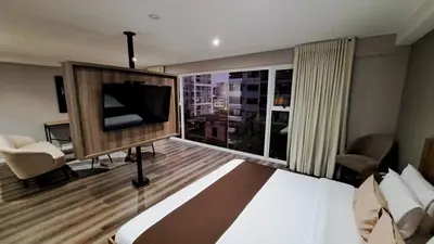 a hotel room with a bed and a large window at Equo Hotel Boutique in Lima