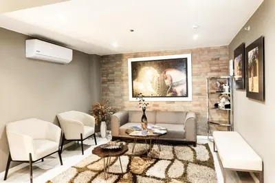 a living room with a couch and chairs at Equo Hotel Boutique in Lima
