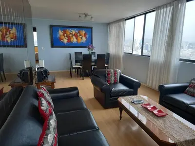 a living room with a couch and chairs and a table at apartamento CAA pardo in Lima