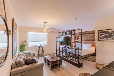 a living room with a bed and a room with a couch at Osma by Wynwood House in Lima