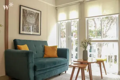 a living room with a blue couch and a table at Osma by Wynwood House in Lima
