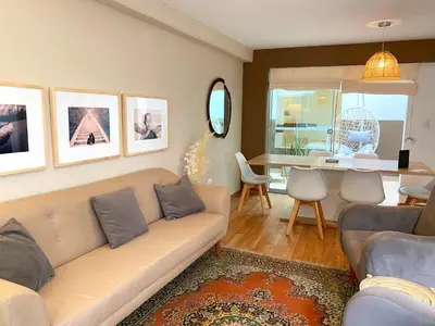 a living room with a couch and a table at Nomad By Wynwood House in Lima