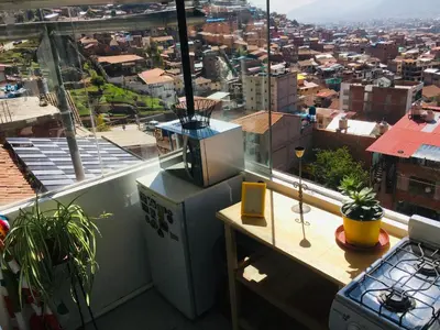 a balcony with a view of a city at Sunny Apartment in Cusco