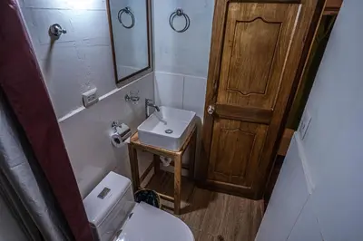 a small bathroom with a toilet and a sink at MAMA GREEN HOSTAL - Eco Andean Experience and Permaculture Farm - Vegetarian Breakfast in Urubamba