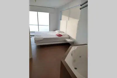 a bathroom with a bed and a bath tub at PARACAS megaview bayfront flat in Paracas