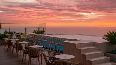 a rooftop bar with tables and chairs and a pool at SOUMA Hotel, Vignette Collection by IHG in Lima