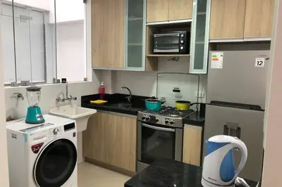 a small kitchen with a stove and a dishwasher at 7-Departamento moderno en el área turística de Miraflores in Lima