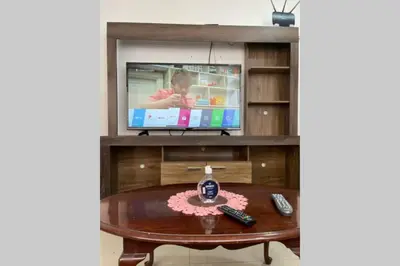 a living room with a tv and a table at (5)Modern Miraflores tourist area apartment in Lima