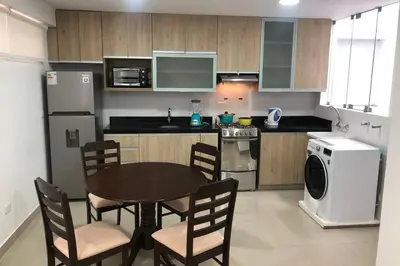 a kitchen with a table and chairs in a kitchen at (5)Modern Miraflores tourist area apartment in Lima