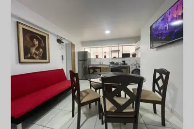 a living room with a red couch and a table at (4)Acogedor departamento, excelente ubicación in Lima
