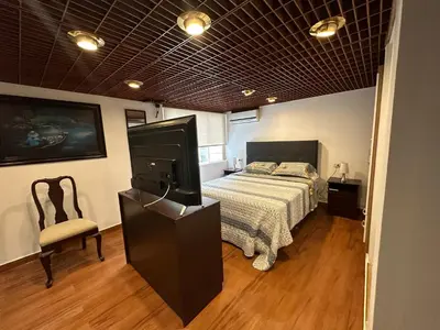 a bedroom with a bed and a tv in it at 2- Amplio Departamento remodelado en Miraflores in Lima
