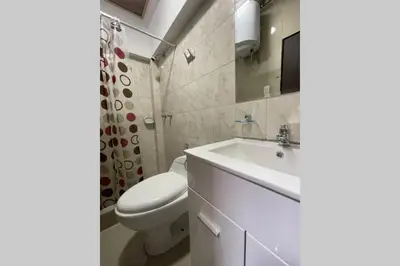 a white bathroom with a toilet and a sink at 4B Mini-departamento nuevo en centro de Miraflores in Lima