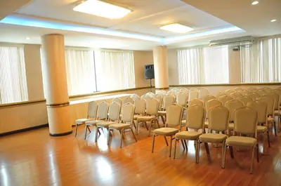 a room with rows of chairs and a podium at Kingdom Hotel in Lima