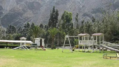 a park with a bunch of swings in a field at Guizado Portillo Hacienda & Resort in Lunahuaná