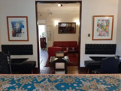 a living room with chairs and a red couch at Hospedaje Santa Rosa- Centro Histórico in Lima