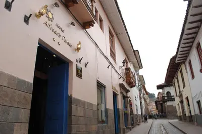 a building with a blue door on a street at Hostal Alfredo's Palace in Cusco