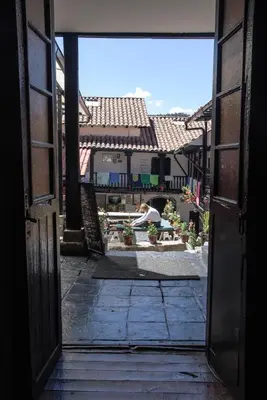 an open door of a building with a view of a courtyard at Intro Hostels Cusco in Cusco