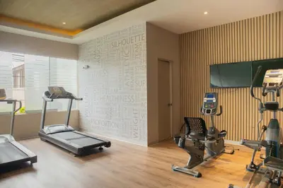 a gym with two exercise bikes and a wall with writing on it at Martinto 114 by Wynwood House in Lima