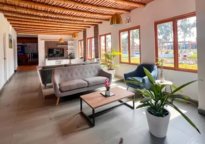 a living room with a couch and a table at La Estancia Chincha Hotel in Chincha Alta