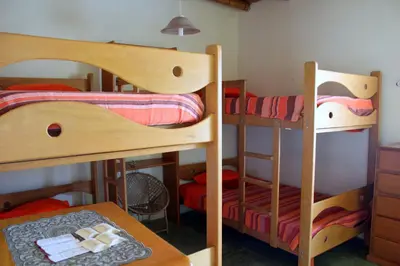 a room with two bunk beds and a table at Huaranjapo in El Carmen