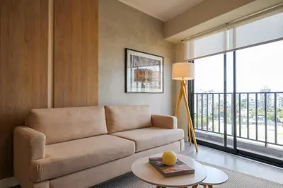 a living room with a couch and a large window at Reducto 825 by Wynwood House in Lima