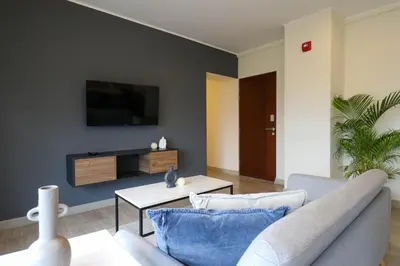 a living room with a couch and a tv on a wall at Reducto 825 by Wynwood House in Lima