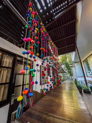 a wall of colorful umbrellas hanging on a wall at Rupa Rupa High Jungle Eco B&B in Machu Picchu