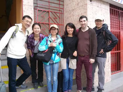 a group of people standing in front of a building at Kurmi Hostel Lima Airport in Lima