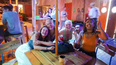 a group of people sitting around a table at Viajero Paracas Hostel in Paracas