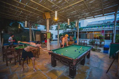 a man playing a game of pool in a restaurant at Viajero Paracas Hostel in Paracas