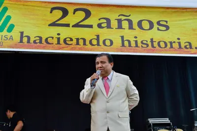 a man in a suit speaking into a microphone at Qala Hotels & Resorts in Chincha Alta