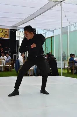 a man in black dancing on a stage at Qala Hotels & Resorts in Chincha Alta