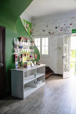 a room with a counter and a green wall at The Secret Garden Hostel in Lima