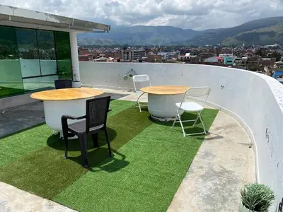 two tables and chairs on the roof of a building at Rooms MD in Huancayo