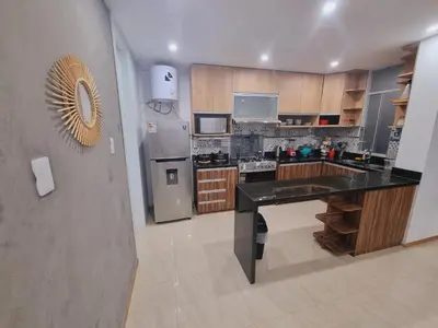 a kitchen with a refrigerator and a counter top at Departamento exclusivo ica in Ica
