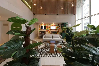 a living room with a couch and some plants at Casa Andina Standard Benavides in Lima