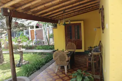 a porch of a house with a table and chairs at Hostal Loma Blanca in Ica