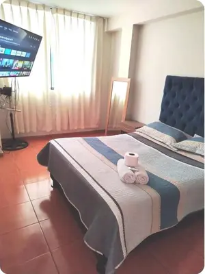 a bedroom with a bed with two towels on it at Hermoso departamento en chorrillos in Lima