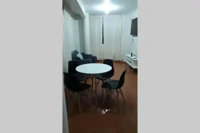 a living room with a table and chairs at Hermoso departamento en chorrillos in Lima