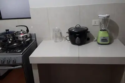 a kitchen counter with a stove and a blender at Hermoso departamento en chorrillos in Lima